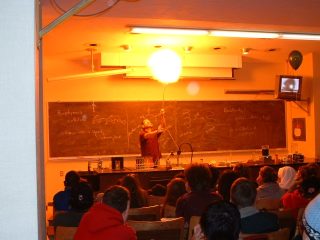 A demonstrator ignites a balloon filled with hydrogen gas