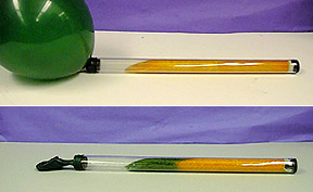 In the first photo, a tube with orange substance is connected to an inflated green balloon. In the second photo, a tube with orange and green substance is connected to a deflated green balloon.