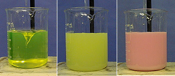 Three beakers with three different colored liquids showing reaction progress