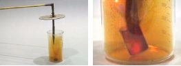 A solid is held in a container with yellow gas and orange liquid. The second photo shows a dark substance and red light appearing around the solid and tip of forceps.
