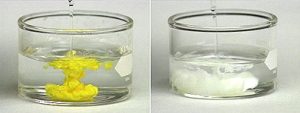 A liquid pours into a container with a yellow solid in the center, and a liquid pours into a container with a white solid in the center.