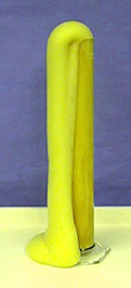 Yellow foam flows out of a glass container.