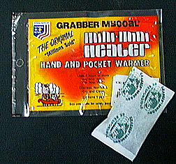 A red and yellow package with white lettering inside a clear bag, and an unopened white bag with dark illustration.