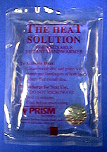 Metal disc in clear liquid inside a plastic bag with red letters