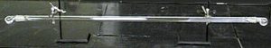 A glass tube with cloudy gas at either end of a long tube with bulbs and an opaque white solid in the middle of the tube.