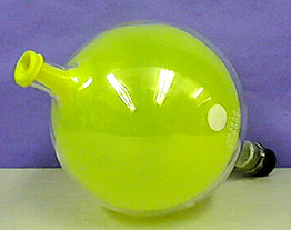An inflated yellow balloon in a clear, capped flask
