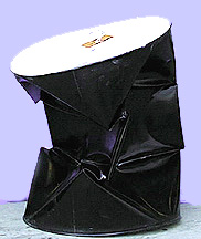 A collapsed black barrel with a white lid
