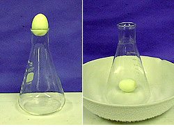In the first photo, an egg sits in the mouth of a flask. In the second photo, the egg is inside the flask in a white bowl.