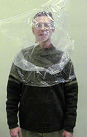 Dr. Rodney Schreiner A professor stands with his head and shoulders inside a plastic bag.