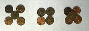 Three sets of copper pennies represent atomic crystal arrangements found in solids