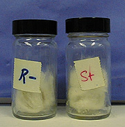 Two capped, labeled jars contain wads of cotton