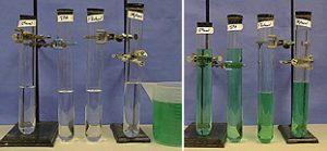 Four ungraduated cylinders with mixtures of green colored water and different alcohols are shown. The smaller chain length alcohols in the two tubes on the left mix with the green water. The longer chain length in the two tubes on the right do not.