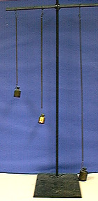 Three weights, each suspended from a spring attached to a crossbar. The crossbar is supported by a stand with a black base.