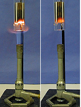Two photos, each showing a solid ceramic  object in a glass tube atop a burner against a blue background. The left photo shows the solid object with a white flame over a lit burner. In the right photo, the object shows an orange glow with no white flame, and the burner is unlit.