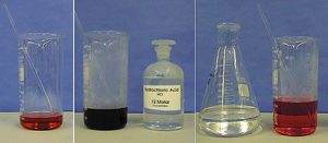 A three-photo sequence: The first photo shows a beaker with clear, red liquid and a stir rod. The second photo shows a beaker with dark blue liquid and a stir rod next to a stoppered, labeled bottle. The third photo shows a flask with clear liquid next to a beaker with red liquid and a stir rod.