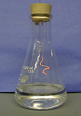A stoppered flask contains an illuminated wire and a clear liquid.