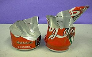 A ripped aluminum can in two pieces