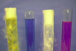 A set of tall cylinders with indicator change colors when dry ice is added.