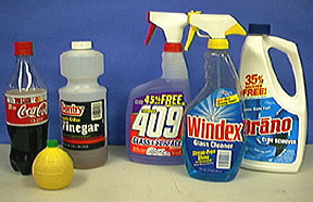 Two groups of containers, one with soda, lemon juice and vinegar, the other with Windex, Draino, and Formula 409 surface cleaner.