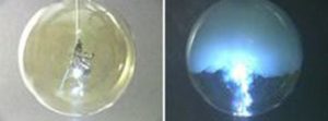 Two photos: A strip of aluminum in a round flask with green gas. The second photo shows the strip illuminated with blue flame and a floating white solid.