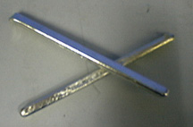 Two tin rods on a gray surface