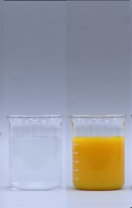 In the first photo, a beaker with a clear and colorless mixture. In the second photo, a beaker with an orange mixture